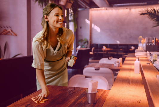 A Gen Z employee is smiling while working at their workplace
